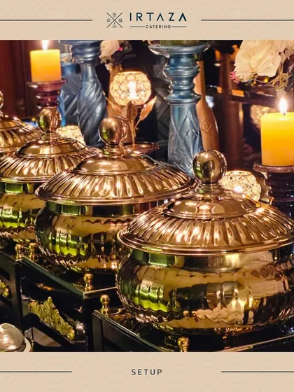 A close-up of my classic golden chafing dishes, reflecting the warm candlelight. This timeless look of elegance is a popular choice for weddings and traditional celebrations.
