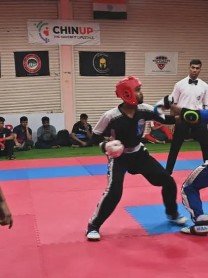 A referee watches closely as two athletes compete. We emphasize fair play and respect for the rules in every match, ensuring a safe and competitive environment.