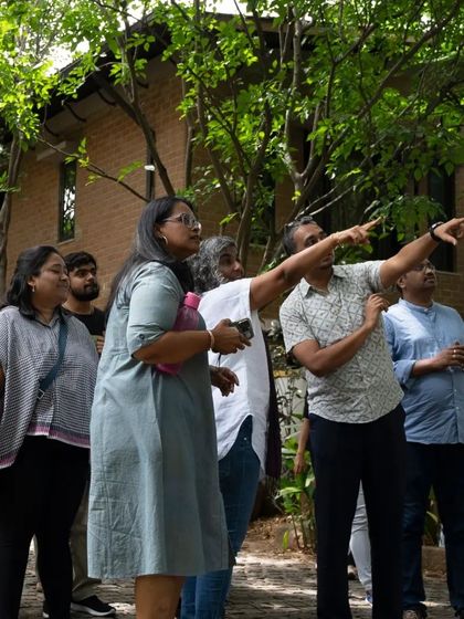 Participants of the "City Explorer" workshop on a guided walk through the Malhar community, learning about sustainable architecture and community planning.
