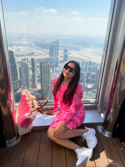 Sitting by the window at the Burj Khalifa, overlooking the stunning Dubai skyline. My comfortable dress and sneakers were perfect for a long day of exploring.