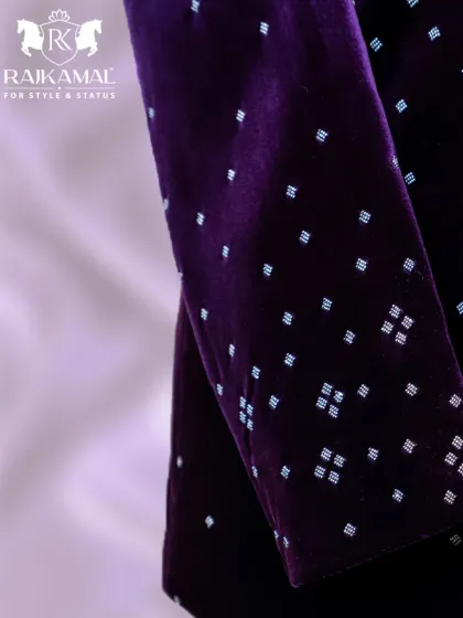 A detail shot of the sleeve of the purple velvet Jodhpuri, showing the continuation of the scattered embellishment pattern.