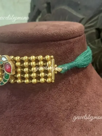 A side view of my Dakshinaya choker, showing the beautiful parrot motif clasp. I believe every detail matters, and this colorful enamel clasp adds a unique and artistic touch to the piece.