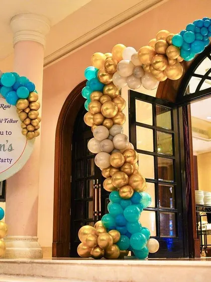 Welcome to the party! We created this custom welcome sign and balloon arch to greet guests for a 15th birthday, setting the tone with a stylish blue, gold, and silver color palette.