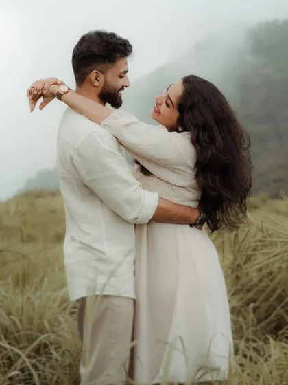 An embrace amidst the clouds. Treesa and Justin's pre-wedding shoot in the misty hills resulted in these beautifully soft and romantic portraits, where the landscape itself seems to hold them close.