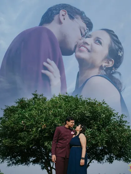 A double-exposure style pre-wedding photo, blending an intimate close-up with a wide shot of the couple under a tree.