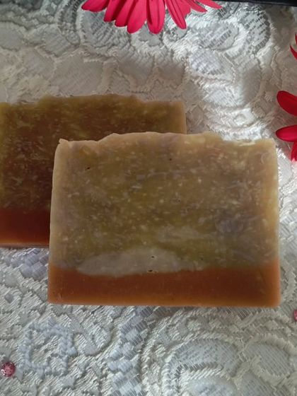 Two bars of Pink Moon soap against a floral background, highlighting its delicate and rosy character.