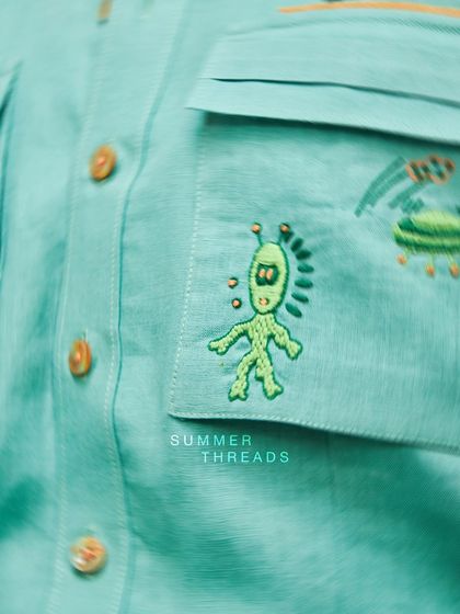 Summer threads that speak volumes. This close-up highlights the quirky alien embroidery on a mint green shirt from my Antriksh collection.