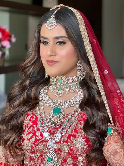 A close-up of this royal red bridal look. We focused on soft, defined eyes and a flawless base to complement the magnificent emerald and diamond jewelry.