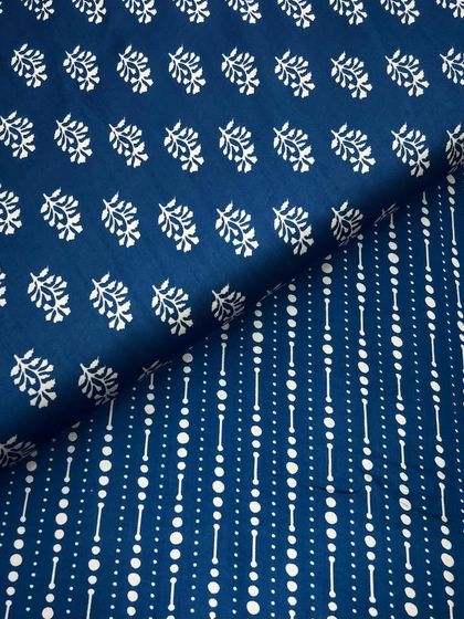 This printed modal satin features a unique combination of a leafy buti print and a geometric dotted stripe. The deep blue color makes it a versatile option for both day and night.