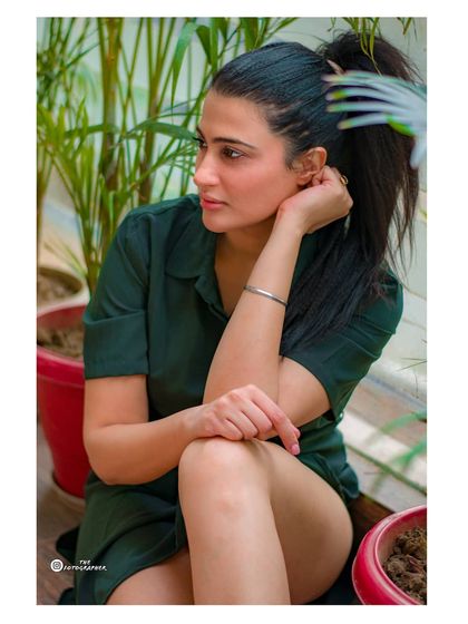 A candid and relaxed portrait taken in a green, leafy setting. This style is perfect for capturing a natural and serene mood.