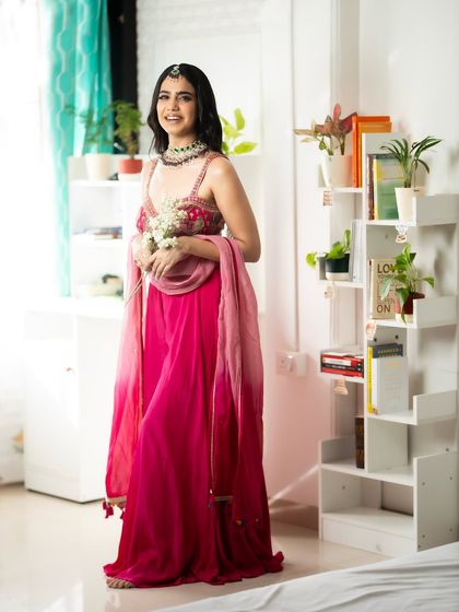 A happy, festive vibe. Holding flowers and smiling, ready to celebrate.