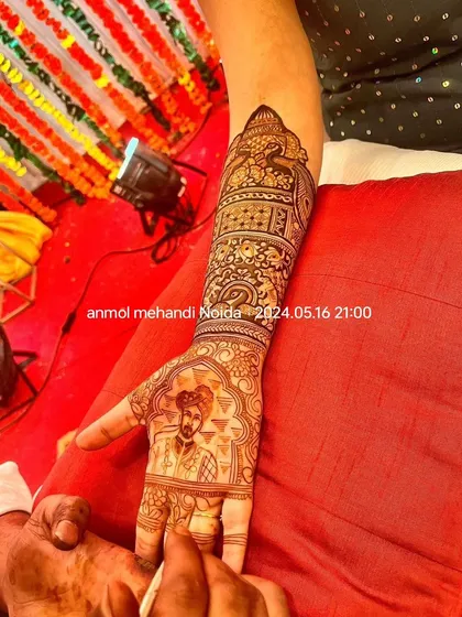A close-up of a groom's portrait being meticulously applied on the bride's palm, showcasing the precision and skill involved in my portrait work.