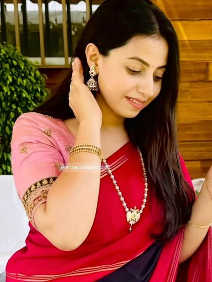 A close-up of the client's custom pink blouse, showing the detailed embroidery on the sleeve cuffs.