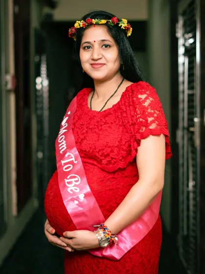 We can incorporate fun props like this 'Mom To Be' sash to celebrate your journey. It adds a joyful and personal element to your maternity portraits.