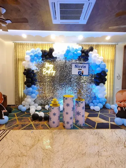 A full view of the Boss Baby decoration in a home setting. This shows how I can transform a living room with a shimmer wall, balloon arch, and life-sized character cutouts to create an immersive party experience.