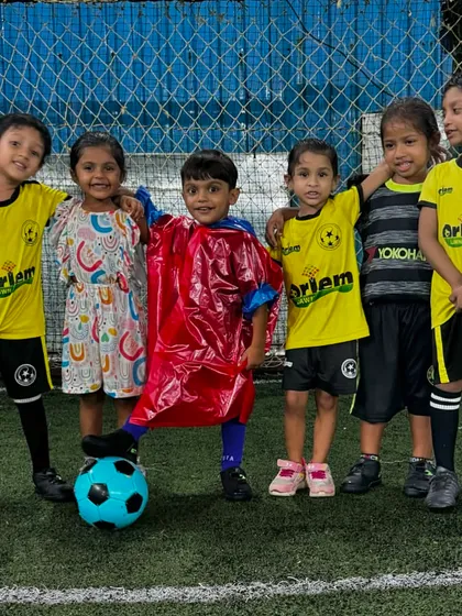 Rain and football, a perfect combination. Our toddlers enjoying their session, with one player even wearing a raincoat over his jersey.