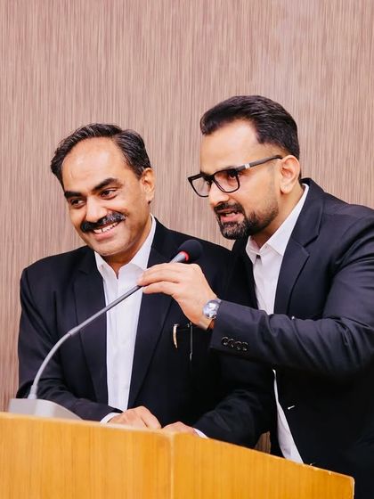 Sharing a light moment at the podium during the crèche inauguration ceremony. Building a positive and friendly relationship between the bar and bench is essential.