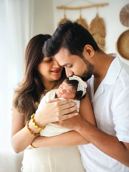 A close family embrace, with dad kissing his baby's head. These photos are about capturing the feeling of being a new family.