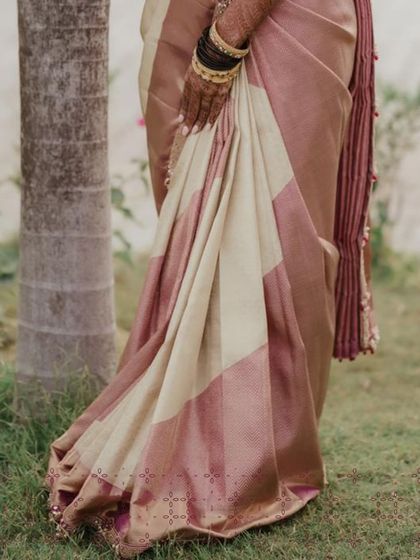 The luxurious fall of a custom designed Kanjivaram silk saree. The subtle sheen of the fabric and the traditional border are hallmarks of a timeless bridal piece.