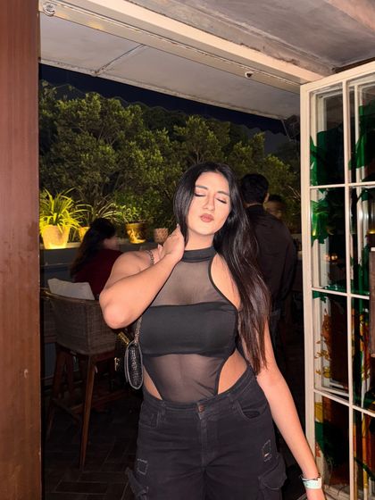 A candid, eyes-closed moment in the edgy outfit.