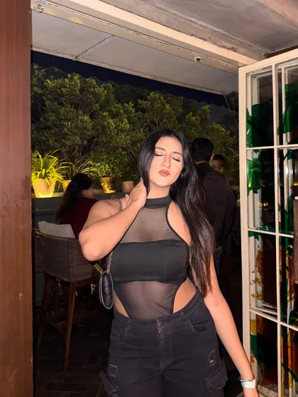 A candid, eyes-closed moment in the edgy outfit.