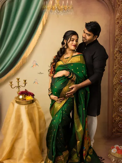 A regal portrait of an expecting couple. The rich green saree and traditional decor create a majestic feel, perfectly capturing the beauty of a twin pregnancy.