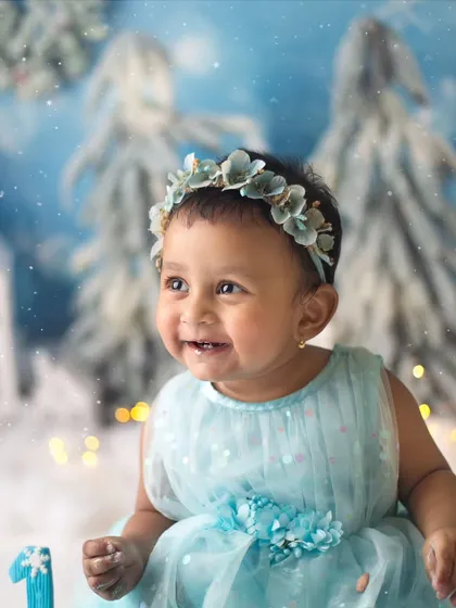 Those happy eyes say it all. This little darling is celebrating turning one with the biggest, most beautiful smile in her own winter wonderland.