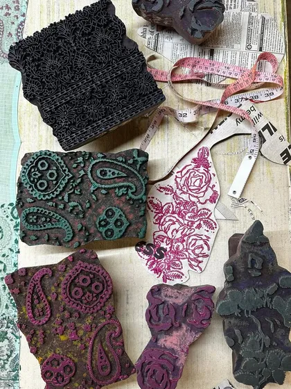 A flat lay showing the combination of vintage blocks and fabric swatches for a summer kota saree. We love mixing timeless floral and paisley prints to create a unique and dreamy aesthetic.