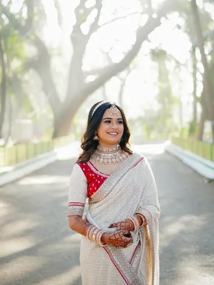 A beautiful portrait of the bride walking down a tree-lined path. The hazy, backlit effect creates a dreamy and romantic atmosphere.