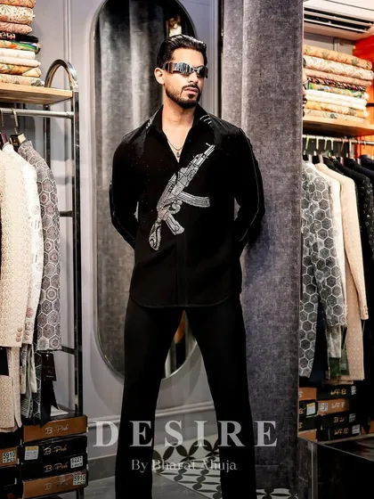 Style as a form of rebellion. This custom black shirt, featuring a bold, embroidered firearm motif, is for the man who plays by his own rules. It merges a sharp silhouette with an edgy design to make an unforgettable statement.