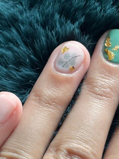 A close-up of the teal and marble design with delicate gold foil and leaf details.