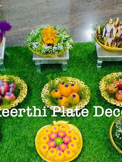 This engagement platter setup in Saibaba Colony features a mix of colorful fruits, sweets, and dolls. The purple-themed doll and flowers add a unique touch.