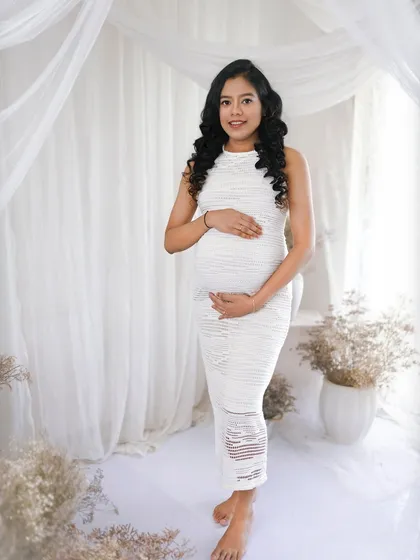 For a clean and timeless look, my bright and airy studio setups are perfect. This portrait captures the pure joy of pregnancy with soft, natural light and a simple, elegant white theme.