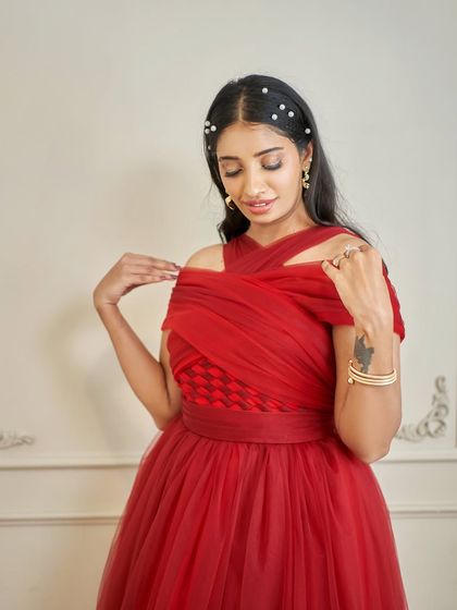 Our 'Sereina' gown in action. This image shows how the detachable sleeves can be added to the criss-cross halter neck for a completely different, off-shoulder style.