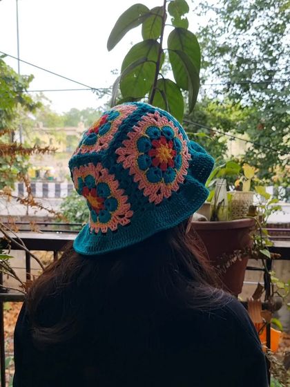 A view of our crochet bucket hat from the back, showing how the colorful granny squares are joined together to create the crown.