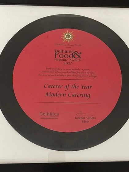 The 'Caterer of the Year 2023' award plaque from the Delhiites Food & Nightlife Awards.