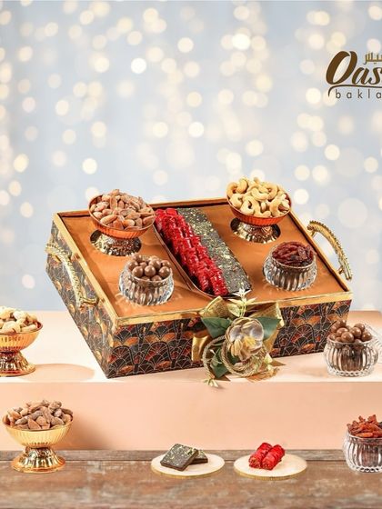 This Diwali, sweeten your celebrations with this opulent hamper. It features a beautiful tray with our sweets and dry fruits in decorative bowls, making it a truly luxurious gift.