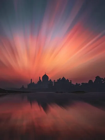 A breathtaking long-exposure shot of the Taj Mahal at sunset, creating a beautiful radial blur effect that showcases the artistic and creative travel photography available.