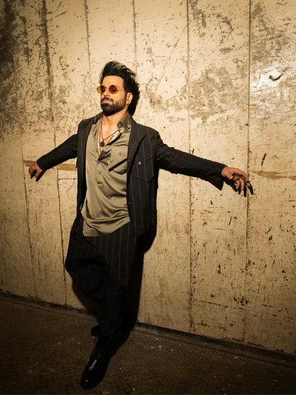 The dynamic movement in this photo showcases the fluidity of the ensemble. The jacket and kurta are designed to move with the wearer, creating a silhouette that is both powerful and graceful.