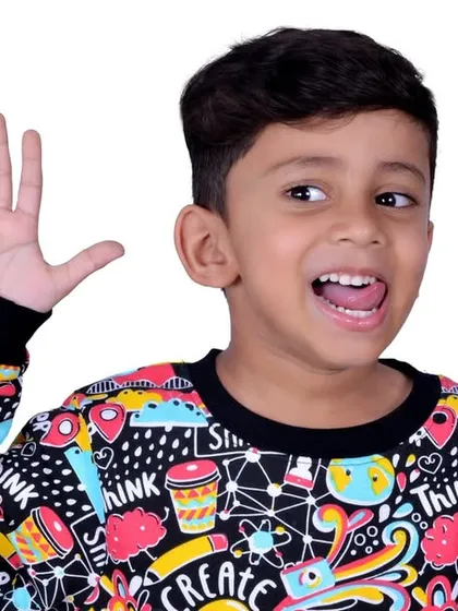 A candid and expressive shot of a young boy during a kids' photography session. I aim to capture the natural energy and personality of children in a comfortable studio environment.