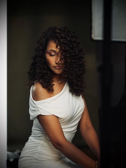 A beautiful, moody shot of our curly-haired model on set during the Bespoke Brunette campaign shoot.