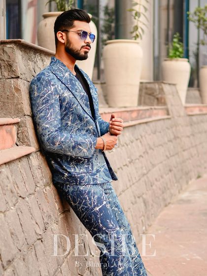 Another angle of the blue splatter-print suit, showing how the pattern moves with the body. It’s a dynamic piece that exudes confidence.