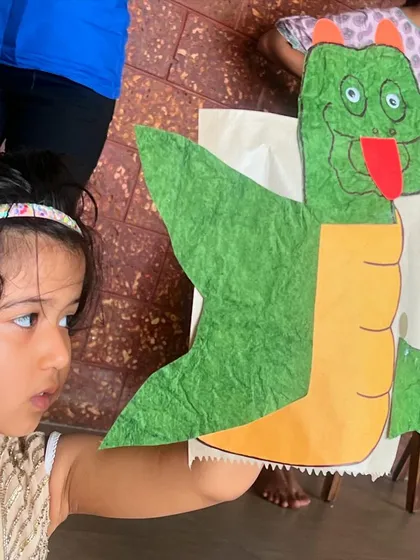The pride on a child's face after they've created their very own puppet is just priceless. In our hands-on craft workshops, every child gets to design, build, and take home a new friend, like this amazing dragon puppet.