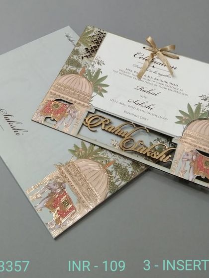A laser-cut invitation with traditional dome motifs and the couple's names in a wooden cutout. This design blends modern techniques with classic Indian architectural elements.