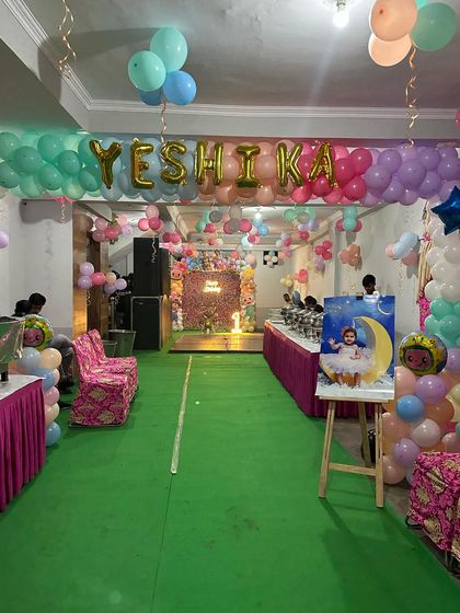 A view of the party hall entrance, with a balloon banner spelling out the birthday girl's name.