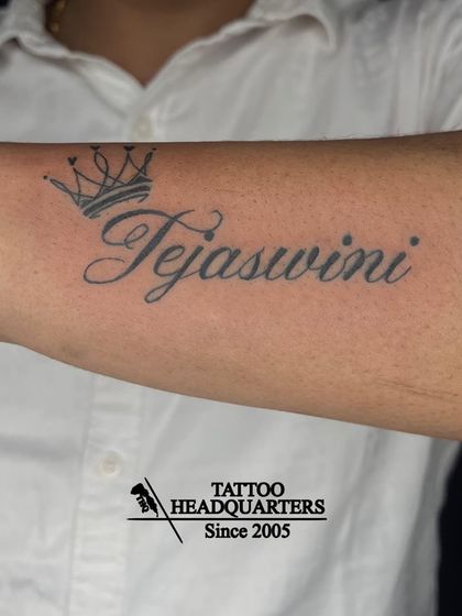 The name "Tejaswini" with a crown tattooed on the forearm, a design that signifies royalty and importance.