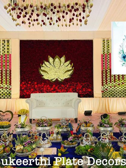 A grand stage with a lotus theme, complemented by my extensive seer varisai arrangement on German silver plates. This shows how my work can enhance even the most elaborate decor.