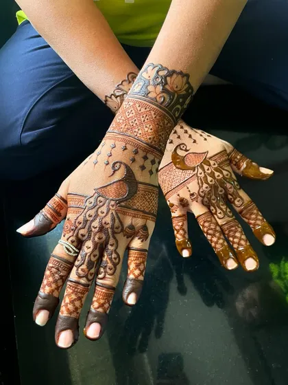 A stunning design with dancing peacocks. The intricate feather details and surrounding patterns create a sense of movement and grace.