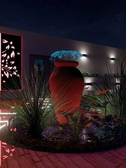 A night-time render of a terrace featuring a large terracotta urn as a water feature. The design uses creative floor lighting and a backlit laser-cut panel to create a dramatic and artistic atmosphere.