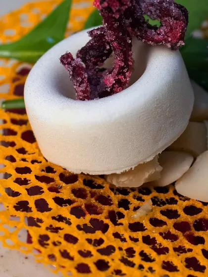 An example of molecular gastronomy, this dish plays with texture and form. The delicate foam and intricate lattice work showcase our chefs' advanced culinary skills.